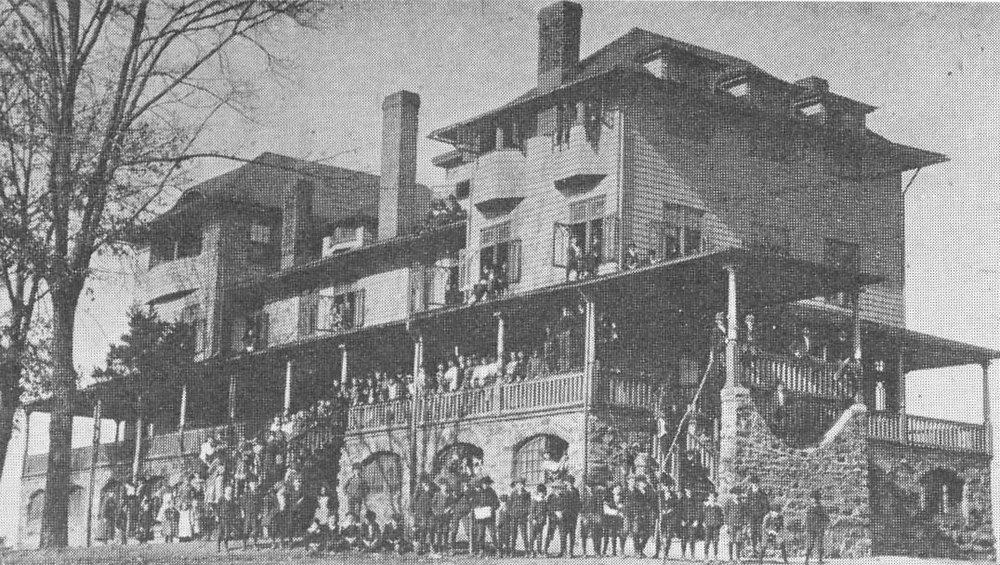 A historic early Piedmont building with a crowd gathered out front